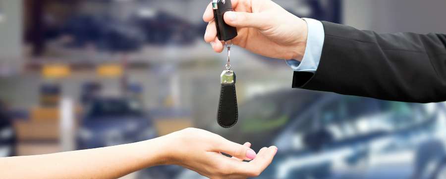 Insurance included - Man handing car keys to woman