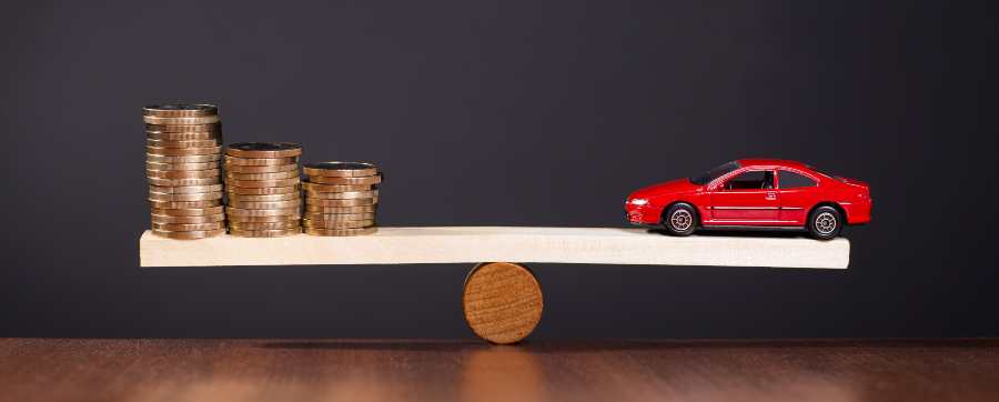 car and money on a seesaw - repayments