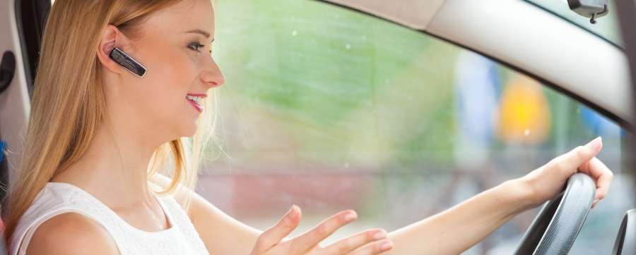 Woman using bluetooth in car