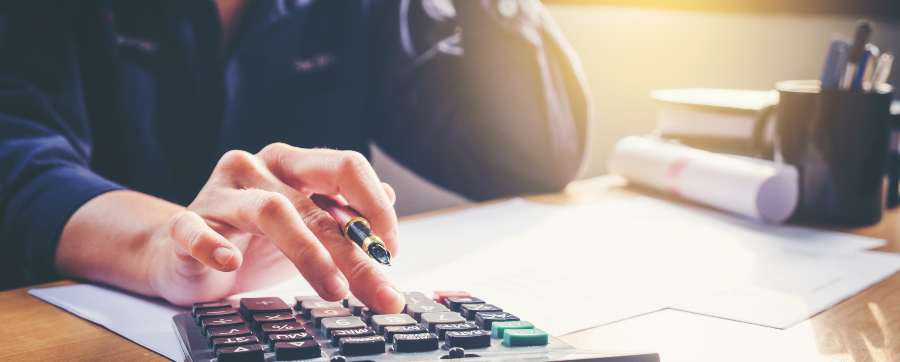 Person doing paperwork with calculator