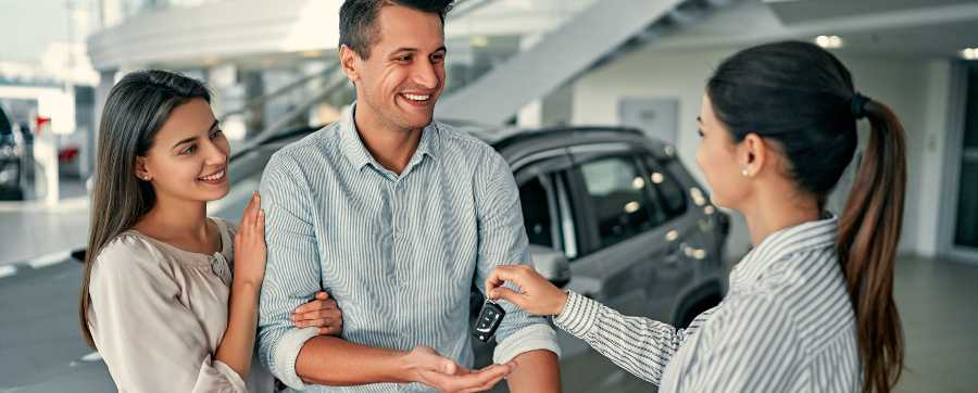 Guaranteed Minimum Future Value - Man and woman getting keys to their new car
