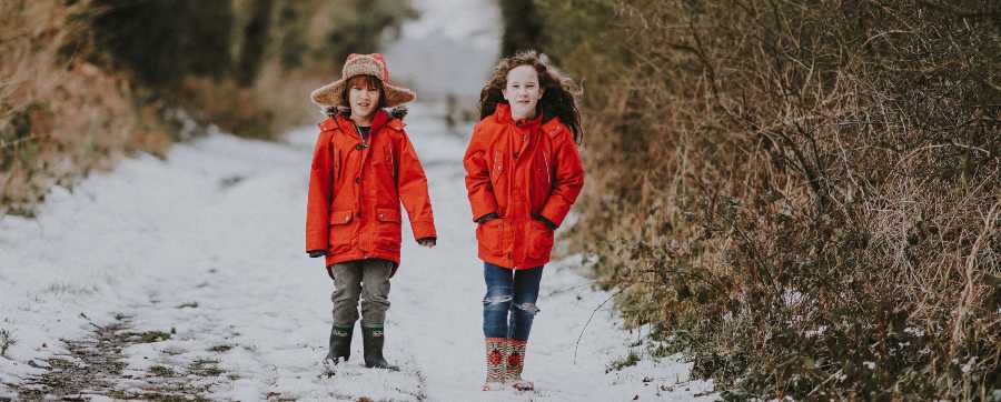 How to keep your vehicle safe in winter - children walking on road in snow