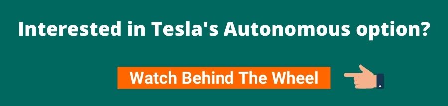 Green background with white text that reads interested in Tesla's autonomous option? Below is an orange button with white text that reads watch behind the wheel on the right of the button is a hand pointing towards it