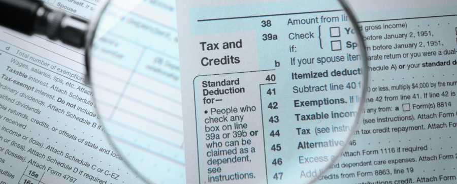 Tax and credits information form with a inspector glass on top