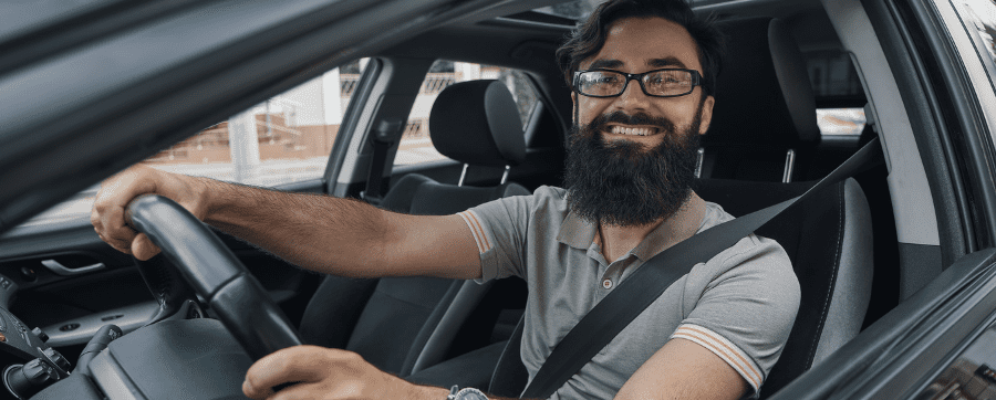 Man smiling in a car