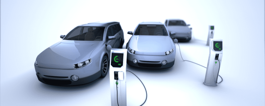 3 grey electric cars plugged into a charger
