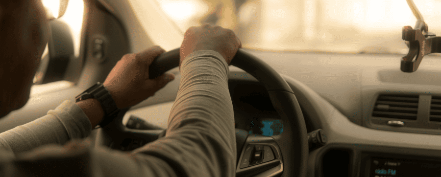 Hands on a car wheel driving