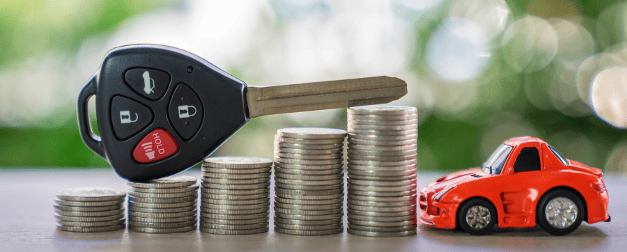 Car key sat on a neat pile of coins with a toy car next to the pile - are car subscriptions worth it