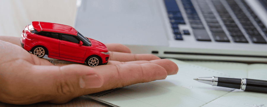 Red small model car on a hand 
