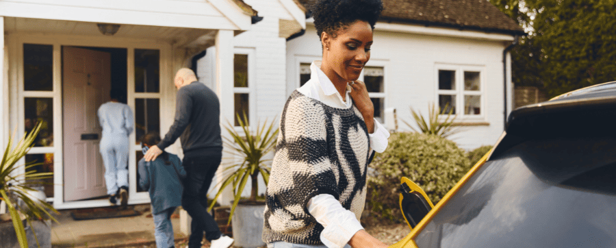 Woman charging her electric car